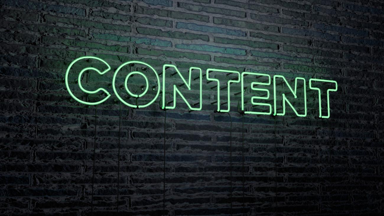 Neon sign on brick wall that reads "content"