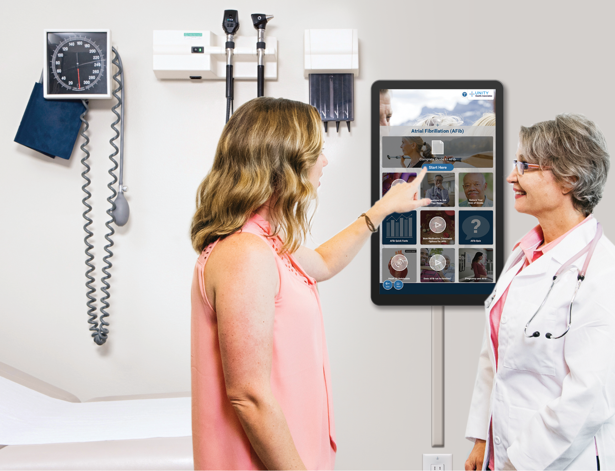 A photo of a doctor using point-of-care technology: showing a patient something on a tablet or on a wall display