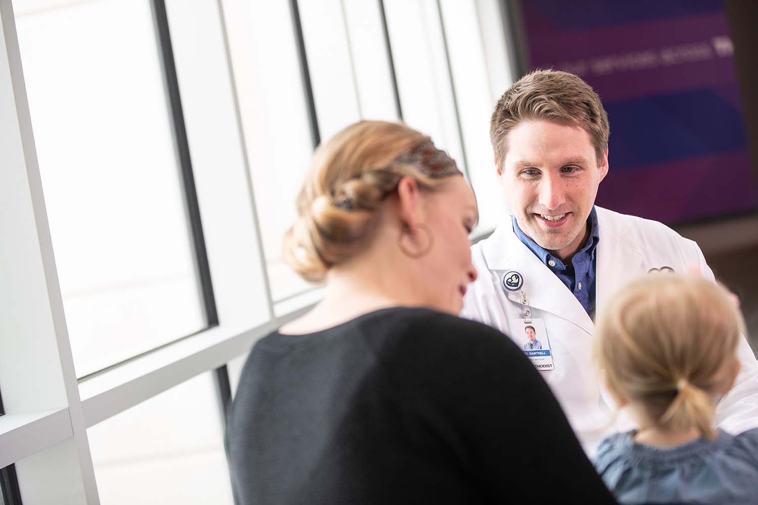 Photo of a doctor with a parent and child