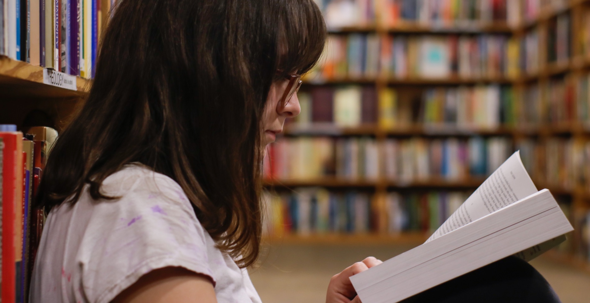 Student reading a book in the library