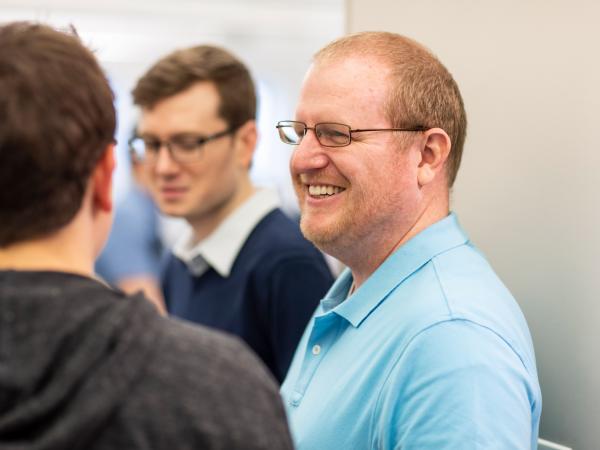 Man in blue shirt smiling