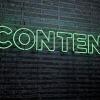 Neon sign on brick wall that reads "content"