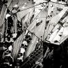 Black and white photo of people in a subway station through multiple reflections