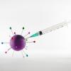 Image of a vaccine needle injecting a model of a virus