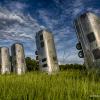 Photo of several old Airstream trailers buried end-up in a field